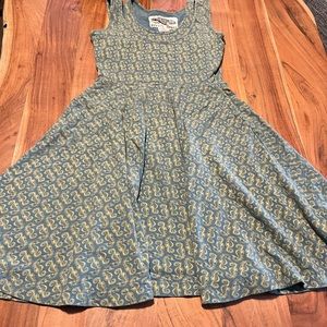 Unique dress. Has double top, pockets. Very comfortable